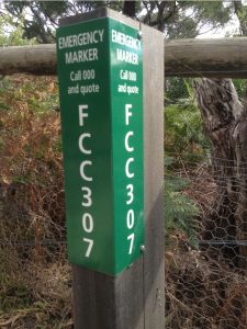 Green emergency marker on fence